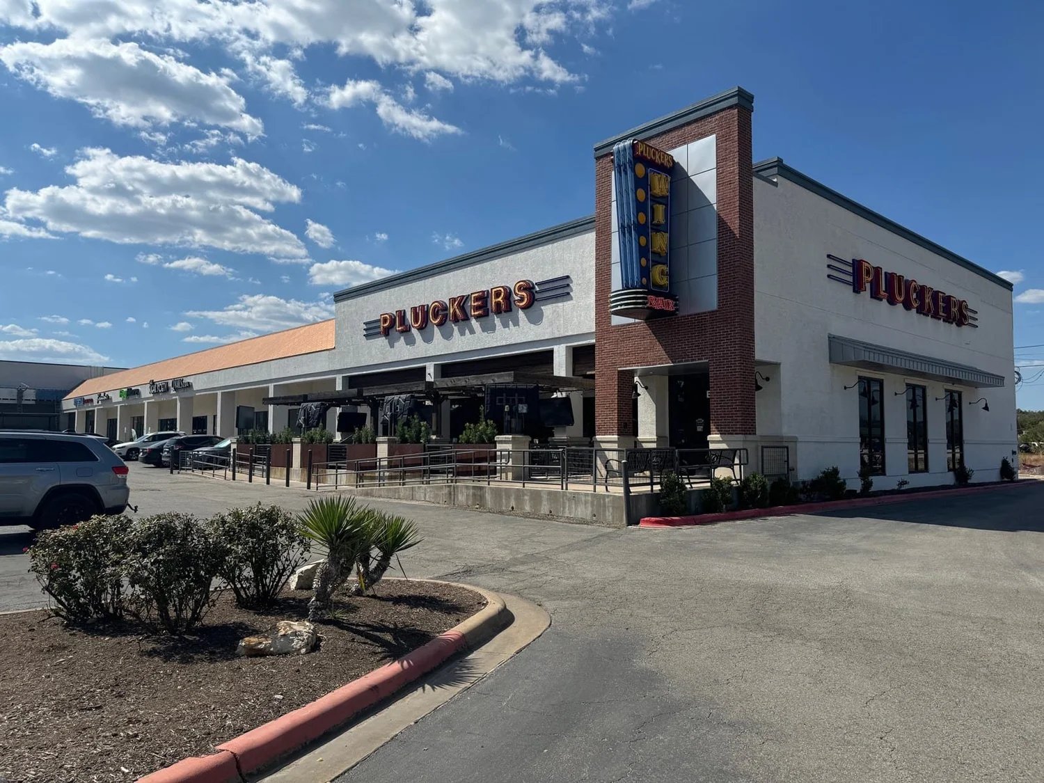 Renovated storefronts at Oak Hill Plaza, anchored by Pluckers