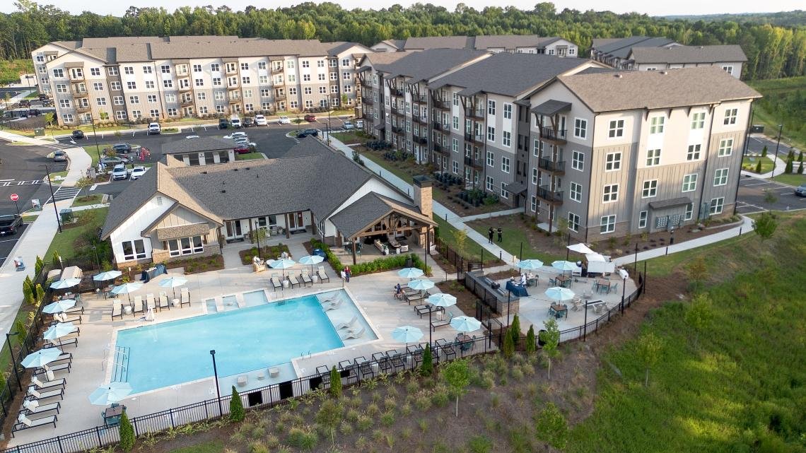 Aerial view of the pool, clubhouse, and residences at NOVEL Douglasville