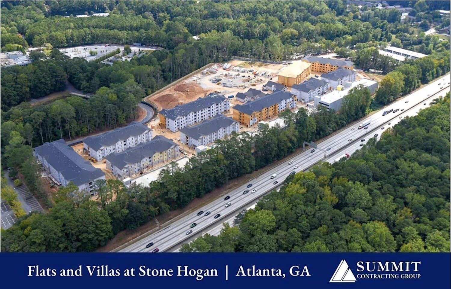 Aerial view of The Flats and Villas at Stone Hogan under construction along the highway in southwest Atlanta