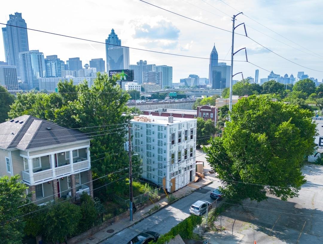 Aerial view of the Firehouse project under construction, with downtown Atlanta in the background