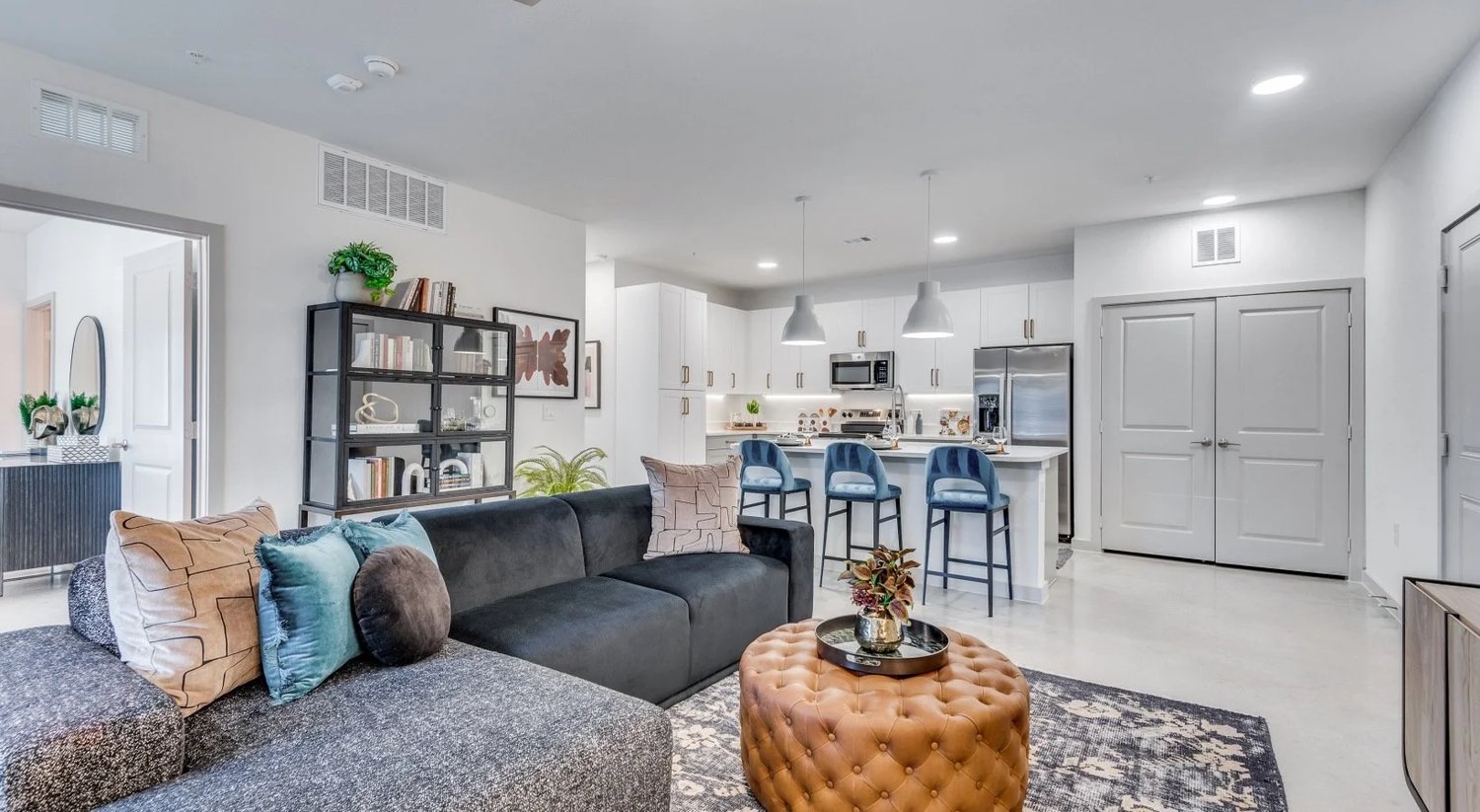 Open-concept living and kitchen area in a model unit at Strata